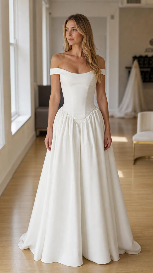 Front view of white off-the-shoulder drop-waist gown