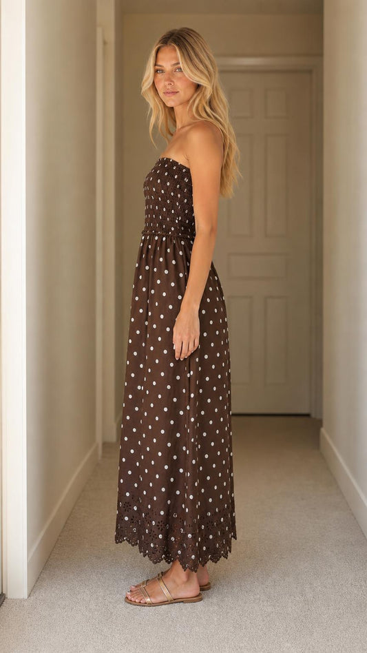 Side profile of woman wearing brown polka dot maxi dress