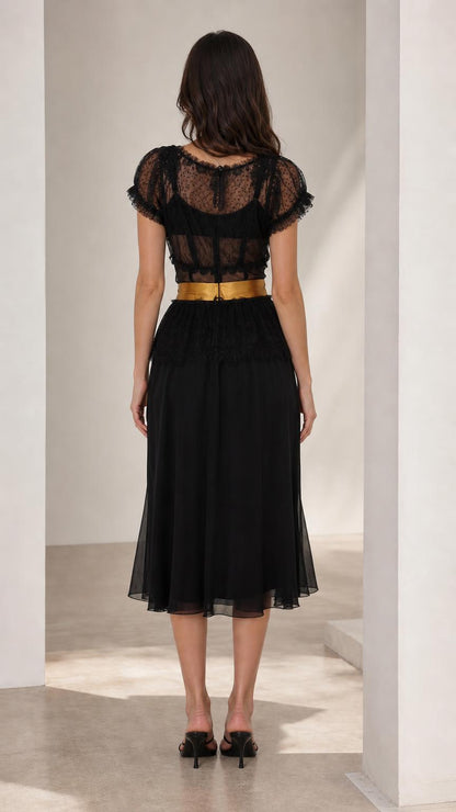 Back view of black midi dress showing sheer lace back